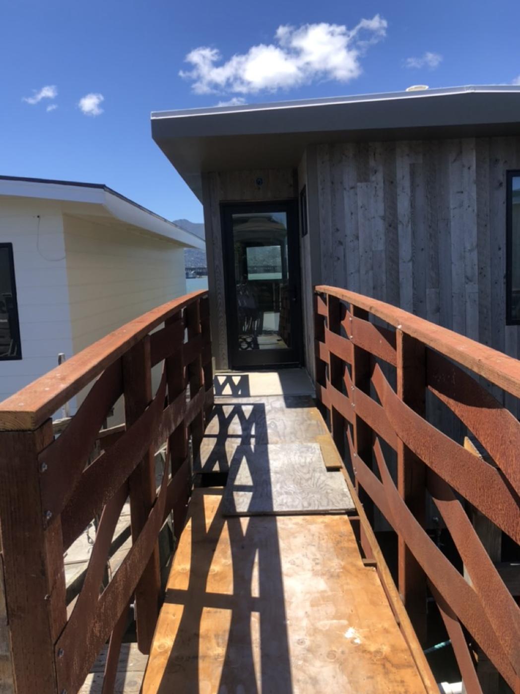 Finished gangway and cedar-sided addition on a renovated Sausalito floating home