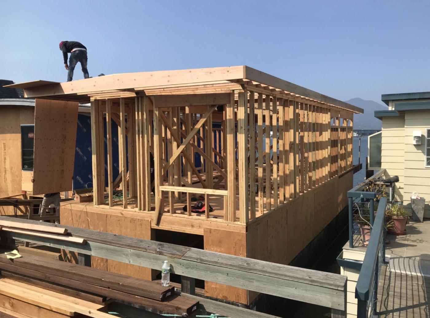 Wood-frame construction of a new floating home addition on the Sausalito docks