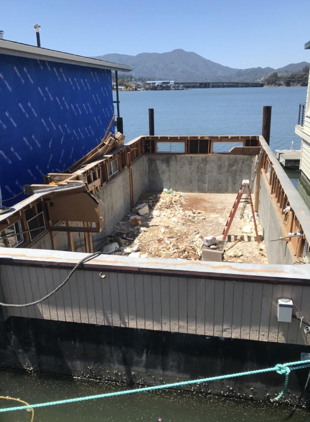 A floating home gutted down to its concrete hull during renovation, Sausalito